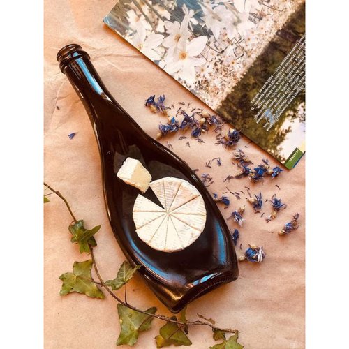 Creative presentation of camembert, brie, mozzarella, tableware from bottles of Champagne Olive Lay Bottle 17269-lay-bottle photo
